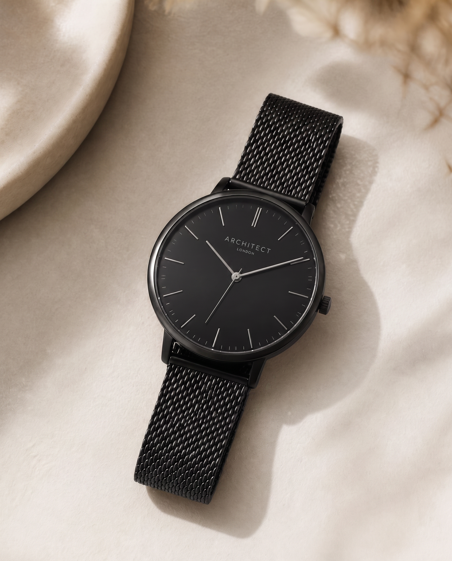 The Architect — black dial minimalist watch on pitch-black stainless mesh